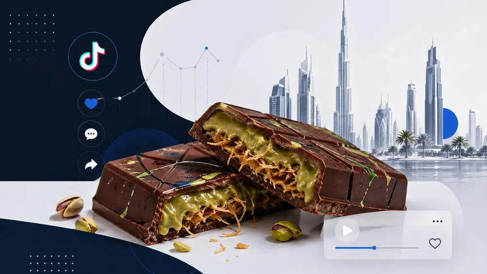Przełamana tabliczka czekolady z pistacjowym nadzieniem i chrupiącym kataifi, symbolizująca viralowy trend czekolady z Dubaju.